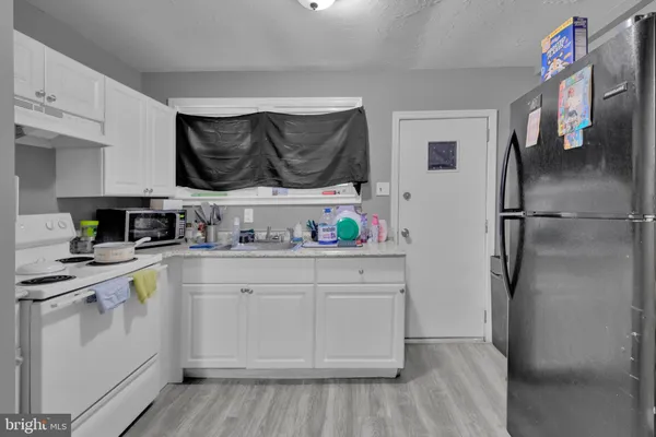 a kitchen with stainless steel appliances a stove a refrigerator and cabinets