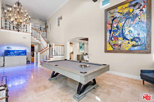 a living room with furniture and wall paintings