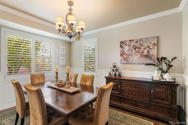a view of a dining room with furniture wooden floor and chandelier