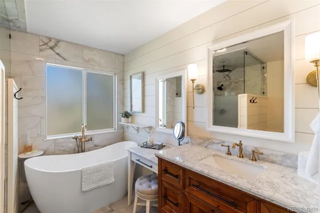 a bathroom with a granite countertop sink and a mirror