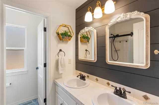 a bathroom with a double vanity sink and a mirror