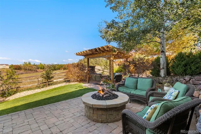 a view of a backyard with furniture and garden