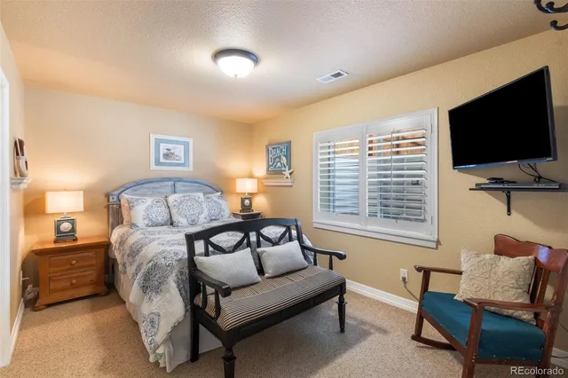 a bedroom with furniture and a flat screen tv