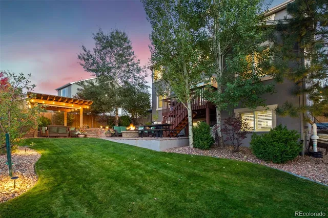 a view of a house with a yard and sitting area