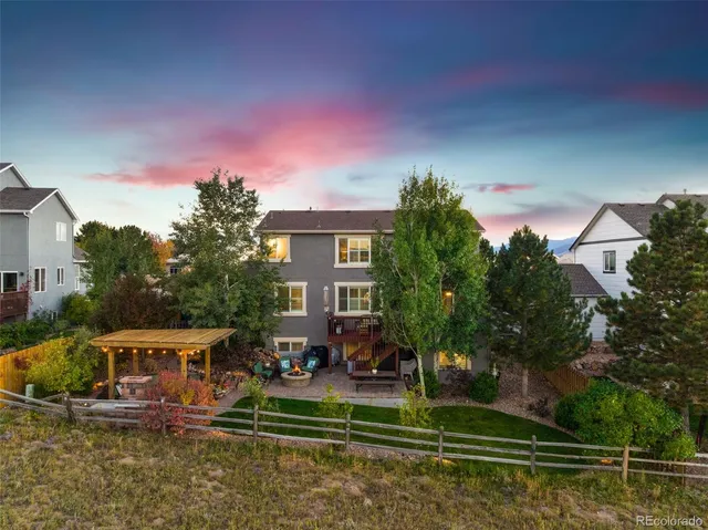 a front view of a house with a yard table and chairs
