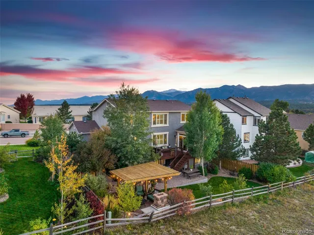 a view of a patio with table and chairs and potted plants