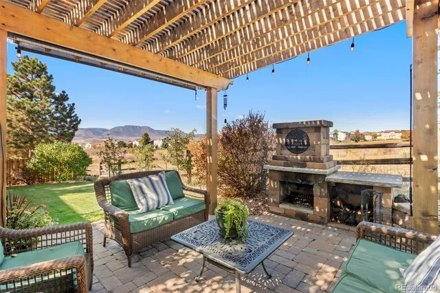a living room with furniture a fireplace and a table
