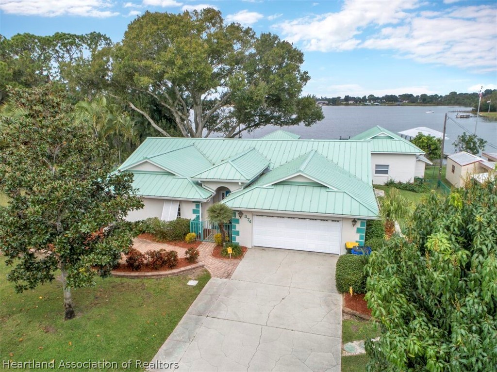 374 Cloverleaf Road Lake Placid, FL 33852 - Photo 1 of 26 a aerial view of a house with a yard and potted plants