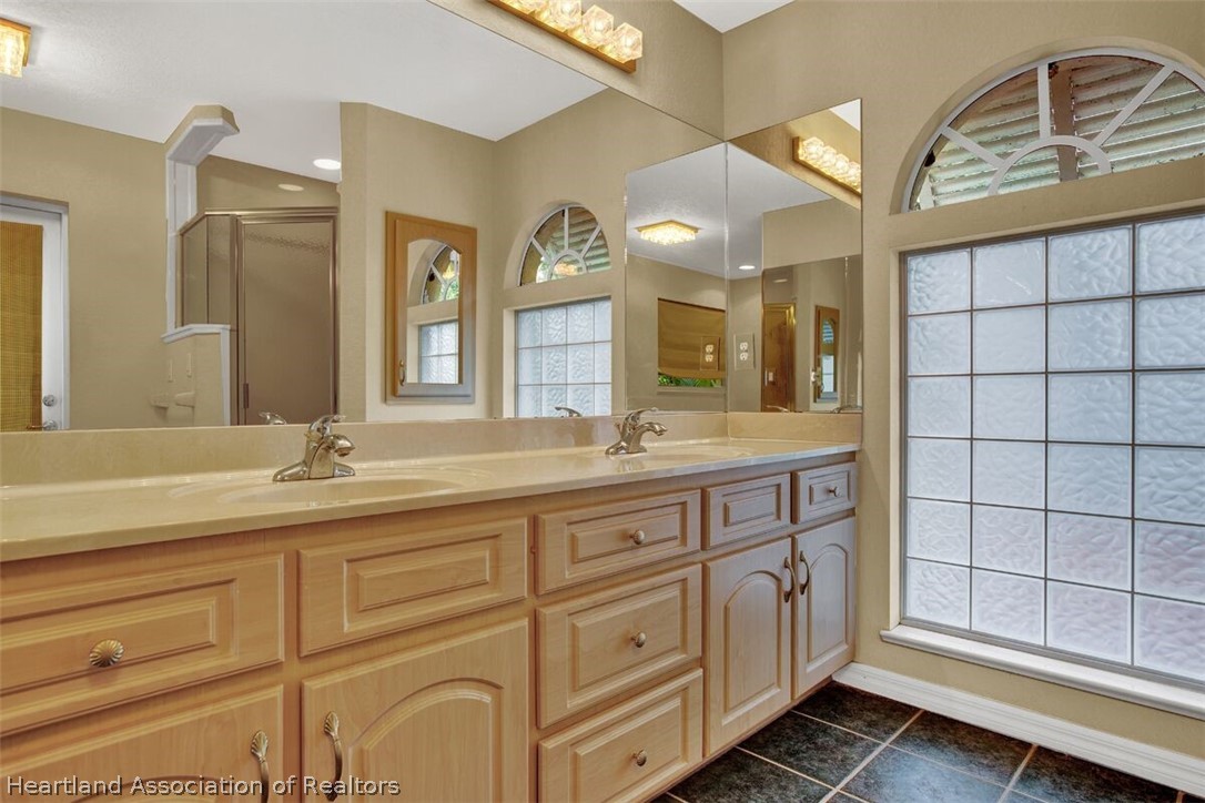 374 Cloverleaf Road Lake Placid, FL 33852 - Photo 12 of 26 a bathroom with a granite countertop sink mirror and
