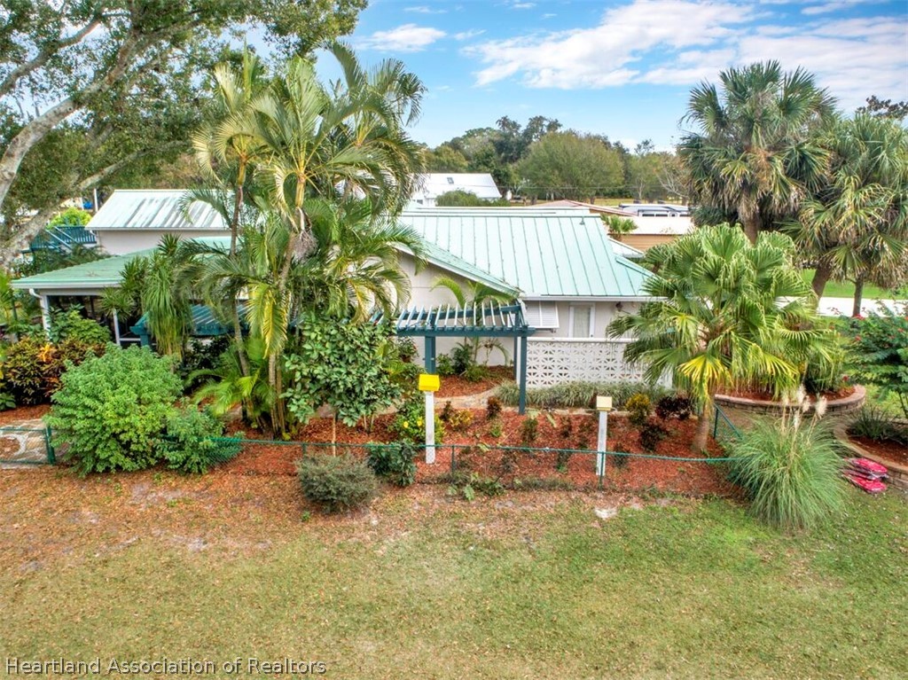 374 Cloverleaf Road Lake Placid, FL 33852 - Photo 23 of 26 a view of backyard with table and chairs and potted plants