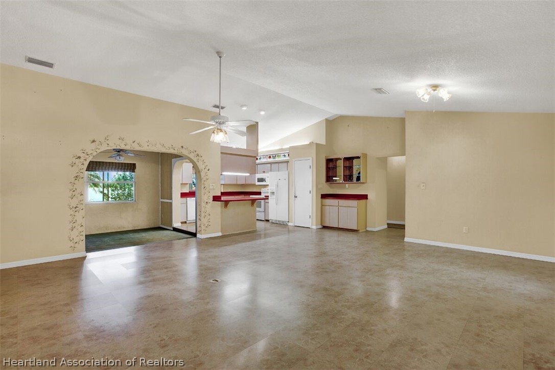 374 Cloverleaf Road Lake Placid, FL 33852 - Photo 4 of 26 a view of a kitchen with a sink a refrigerator and a stove top oven