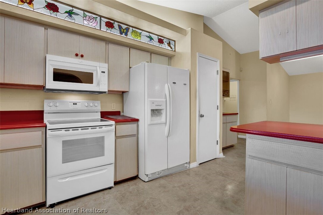 374 Cloverleaf Road Lake Placid, FL 33852 - Photo 9 of 26 a kitchen with stainless steel appliances white cabinets and a refrigerator
