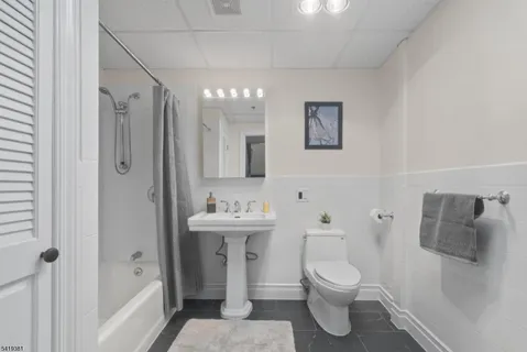 a bathroom with a sink a mirror and a shower