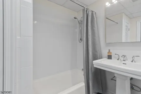 a view of a hallway with entryway wooden floor and staircase