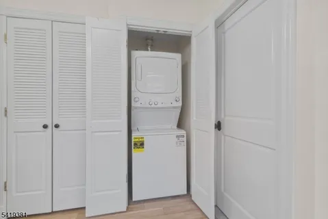 a view of staircase with white walls and a window