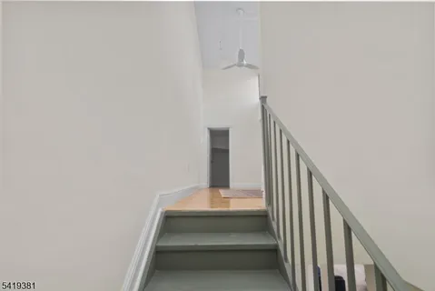 a bedroom with a large bed and a wooden floor