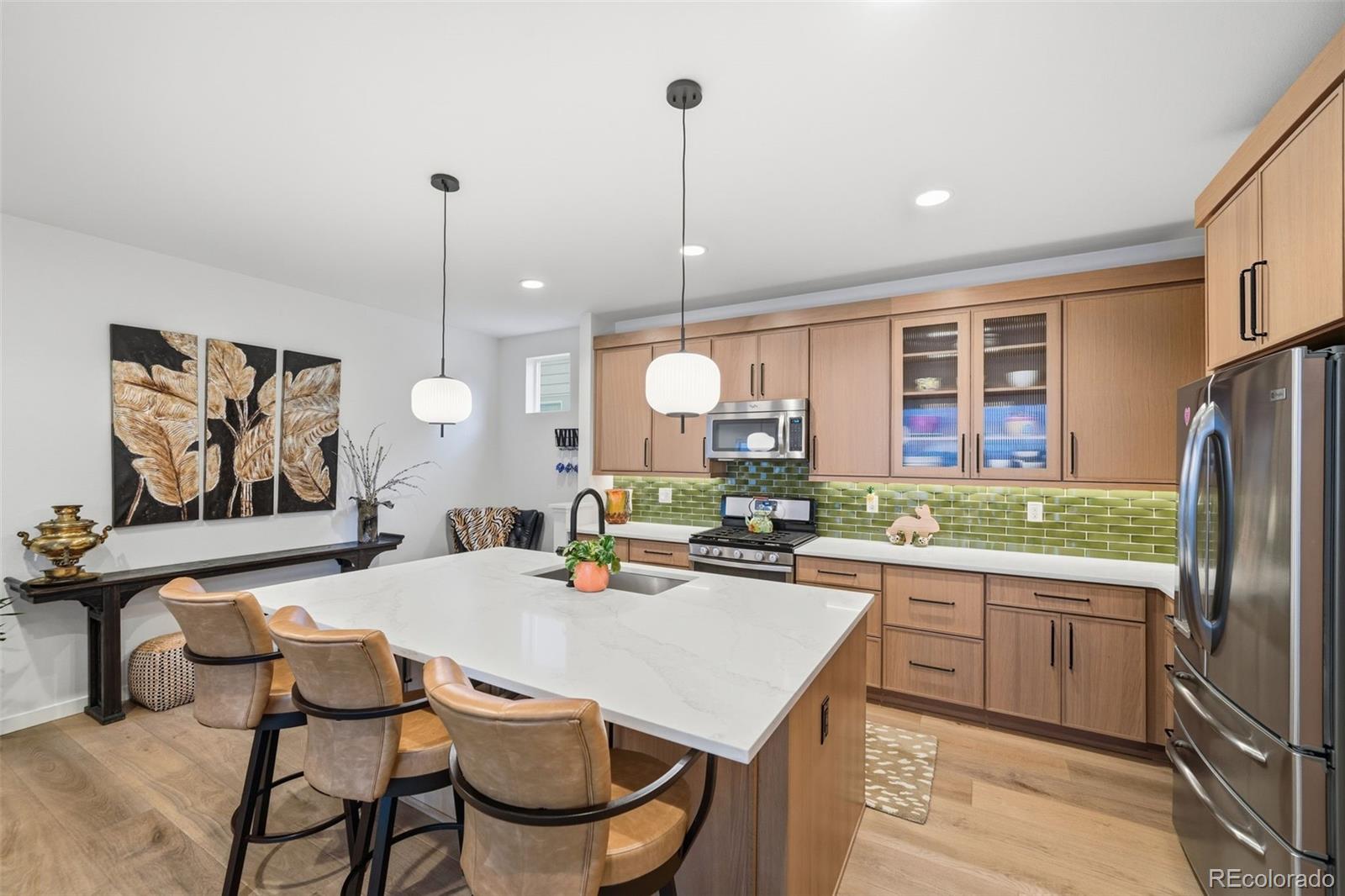 9602 Dunning Circle Highlands Ranch, CO 80126 - Photo 22 of 50 a kitchen with a table chairs sink and refrigerator