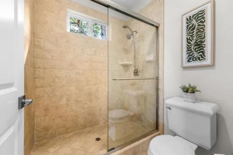 a bathroom with a toilet and a shower
