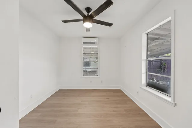 an empty room with a empty space and windows