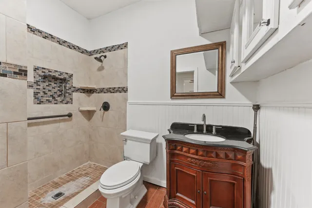 a bathroom with a sink toilet and shower