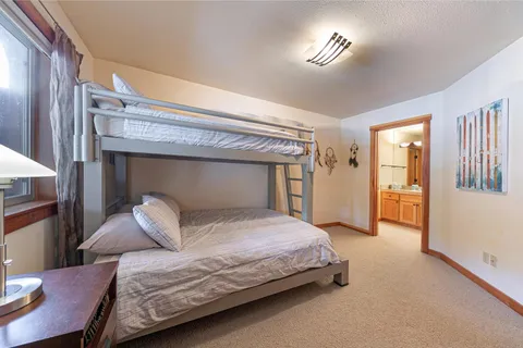 a view of a dining room with furniture a chandelier and wooden floor