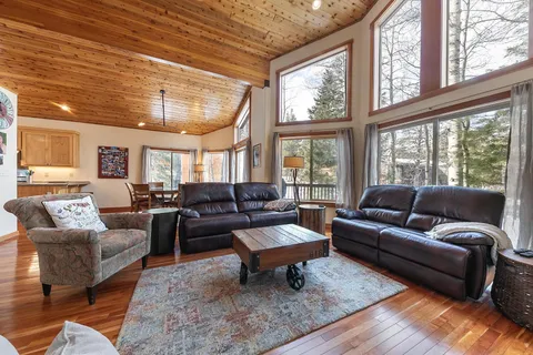a bedroom with a bed and a flat screen tv on dresser