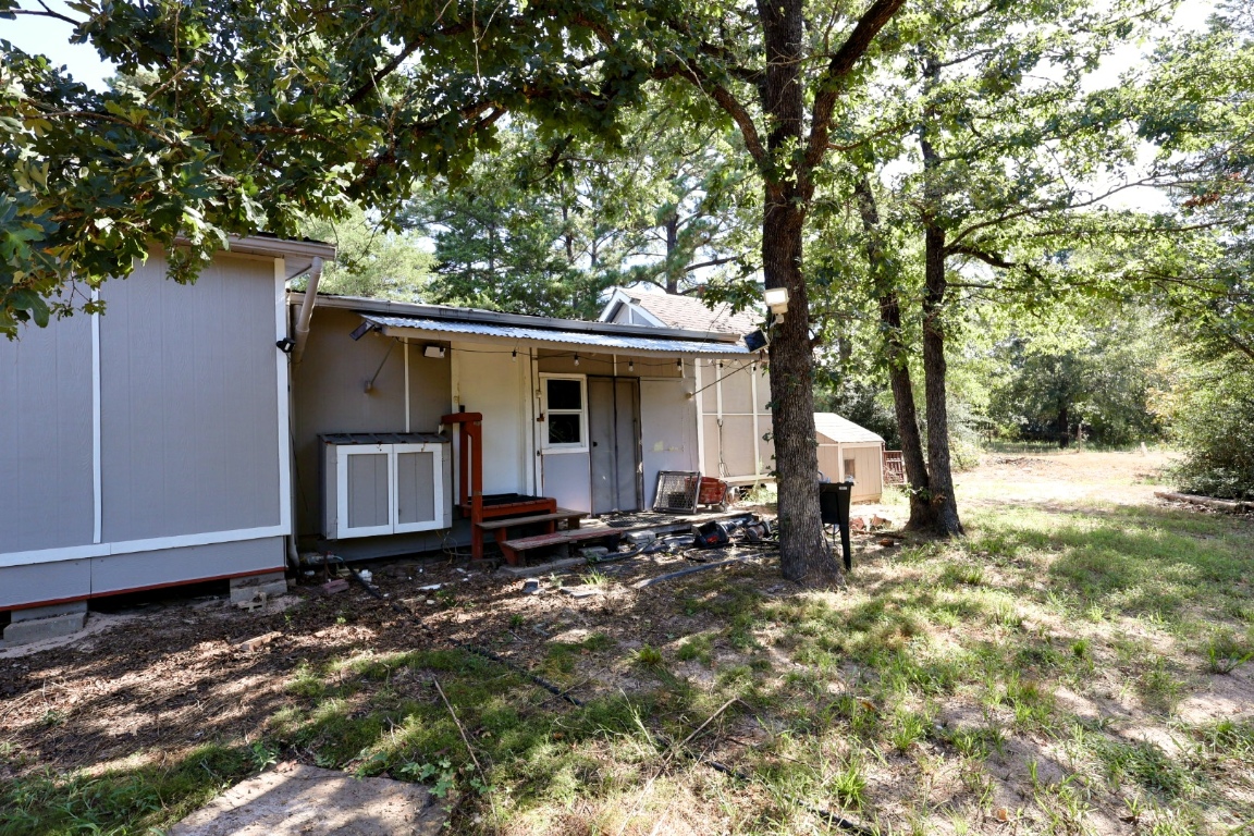109 Travis Road Paige, TX 78659 - Photo 11 of 39 a view of a house with backyard and sitting area