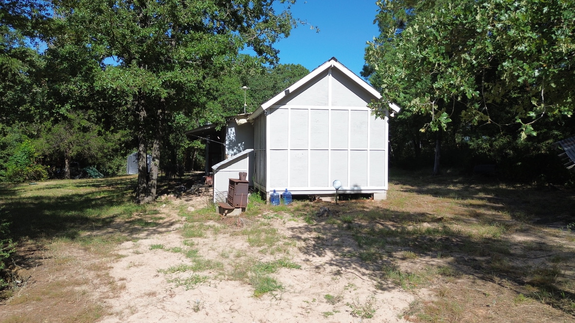 109 Travis Road Paige, TX 78659 - Photo 13 of 39 a view of a house with backyard