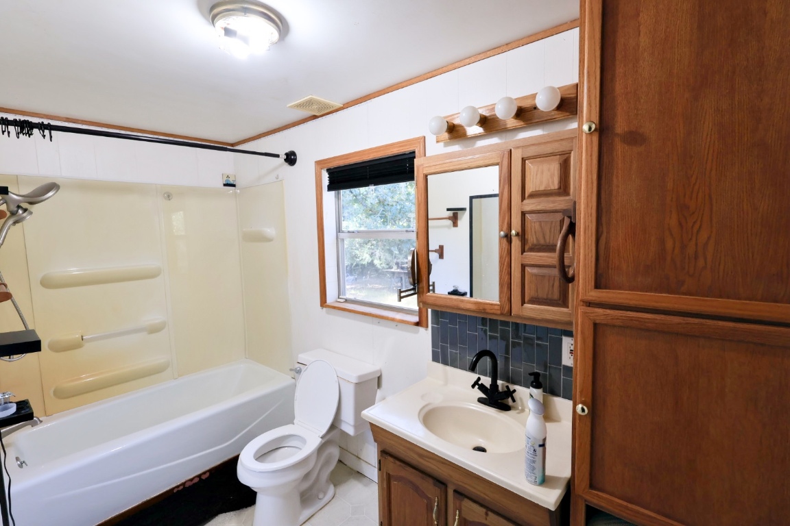 109 Travis Road Paige, TX 78659 - Photo 26 of 39 a bathroom with a sink a toilet and shower