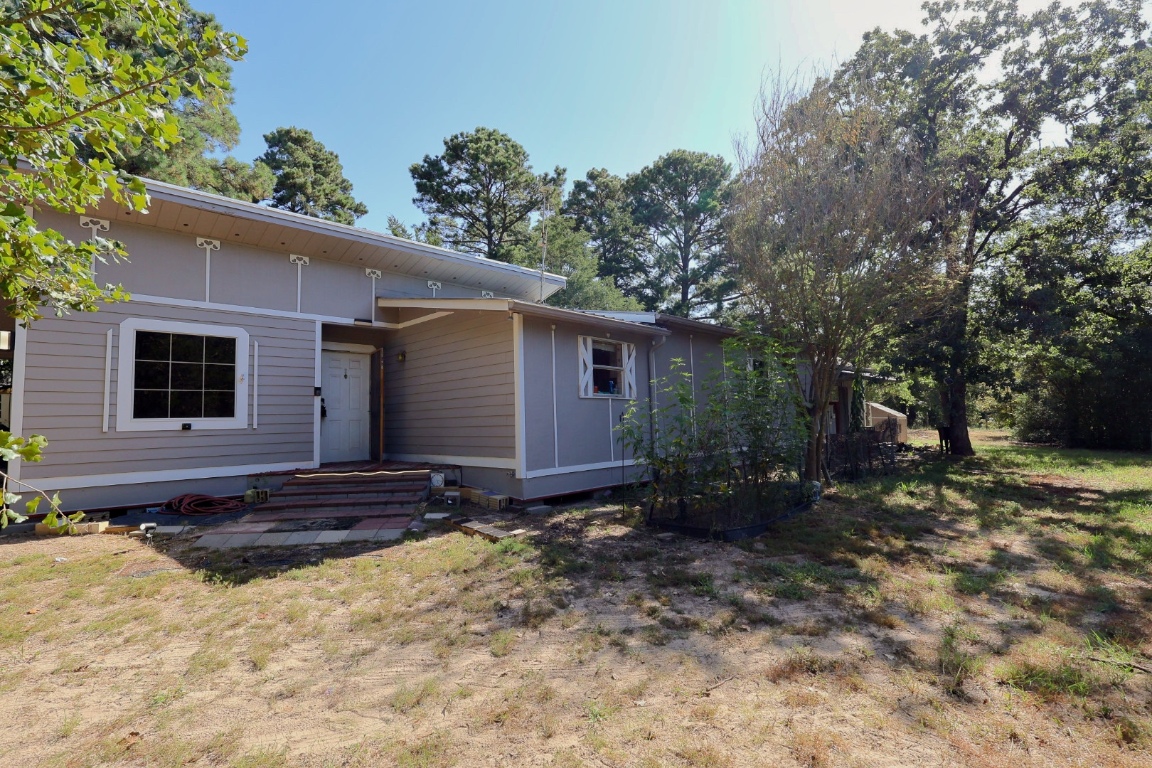 109 Travis Road Paige, TX 78659 - Photo 29 of 39 a view of a house with a yard