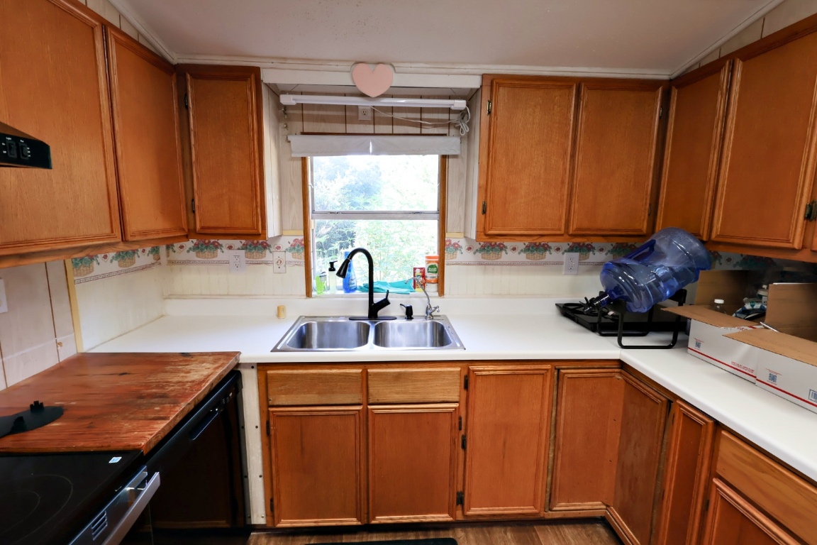 109 Travis Road Paige, TX 78659 - Photo 3 of 39 a kitchen with stainless steel appliances granite countertop a sink stove and cabinets