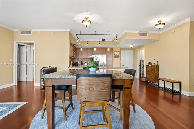 a dining room with furniture and wooden floor