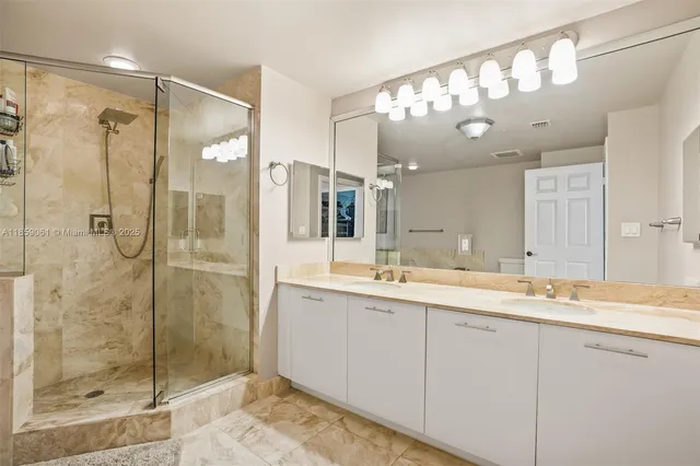 a bathroom with a shower sink and mirror