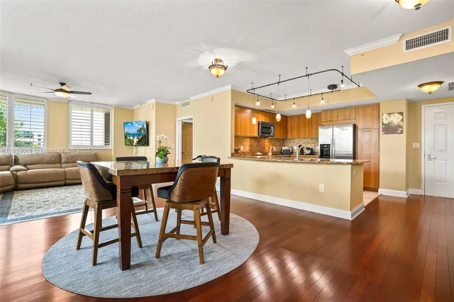 a living room with dining couches and a dining table with kitchen view
