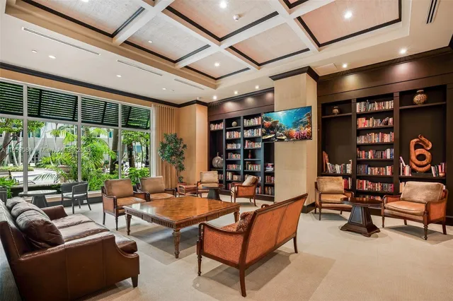 a front view of a multi story residential apartment building with a yard and potted plants
