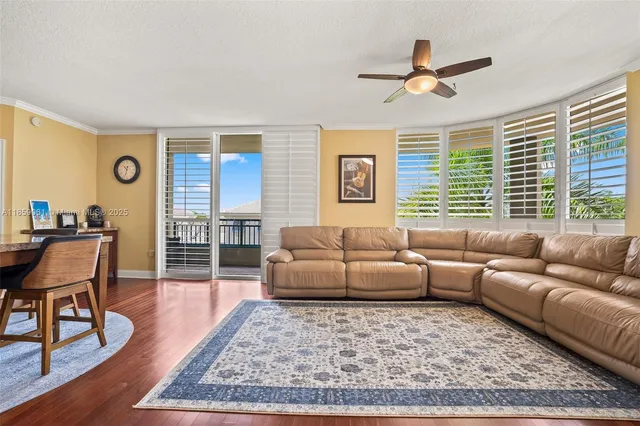 a living room with furniture wooden floor and a window