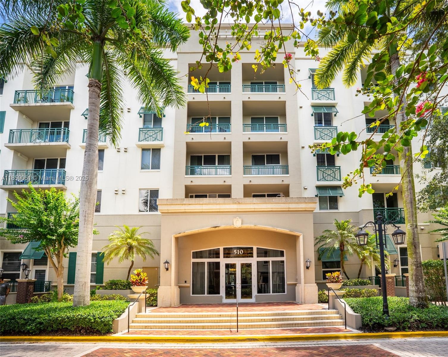 510 Northwest 84th Avenue, Unit 445 Plantation, FL 33324 - Photo 42 of 42 a front view of a multi story residential apartment building with a yard and potted plants