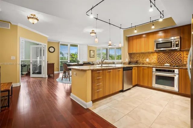 a kitchen with stainless steel appliances granite countertop a stove and cabinets