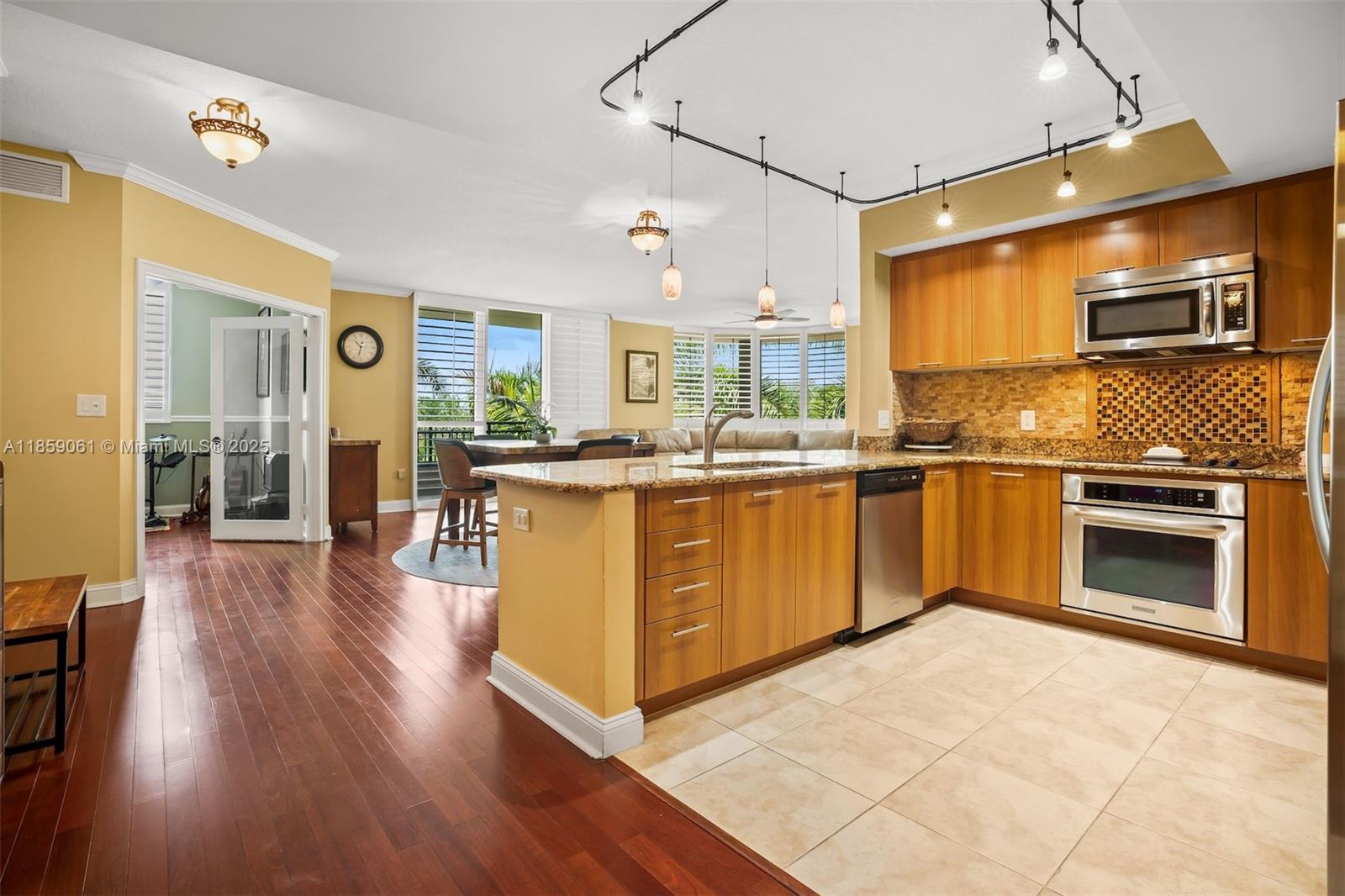 510 Northwest 84th Avenue, Unit 445 Plantation, FL 33324 - Photo 6 of 42 a kitchen with stainless steel appliances granite countertop a stove and cabinets