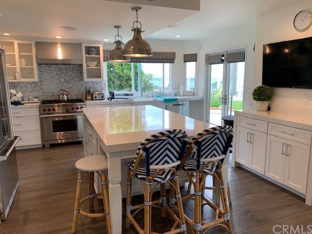 5 Regatta Way Dana Point, CA 92629 - Photo 12 of 36 a kitchen with stainless steel appliances kitchen island granite countertop a stove a sink and a microwave