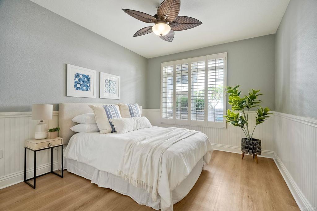 9263 Regents Road, Unit B106 La Jolla, CA 92037 - Photo 12 of 35 a bedroom with a bed and a potted plant