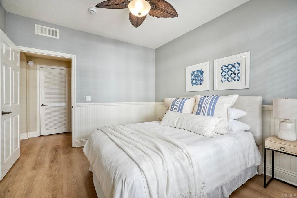 9263 Regents Road, Unit B106 La Jolla, CA 92037 - Photo 13 of 35 a bedroom with a bed and wooden floor