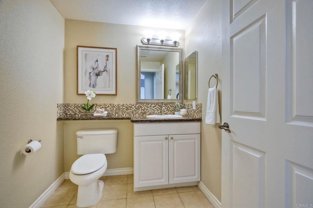 9263 Regents Road, Unit B106 La Jolla, CA 92037 - Photo 15 of 35 a bathroom with a toilet sink and mirror