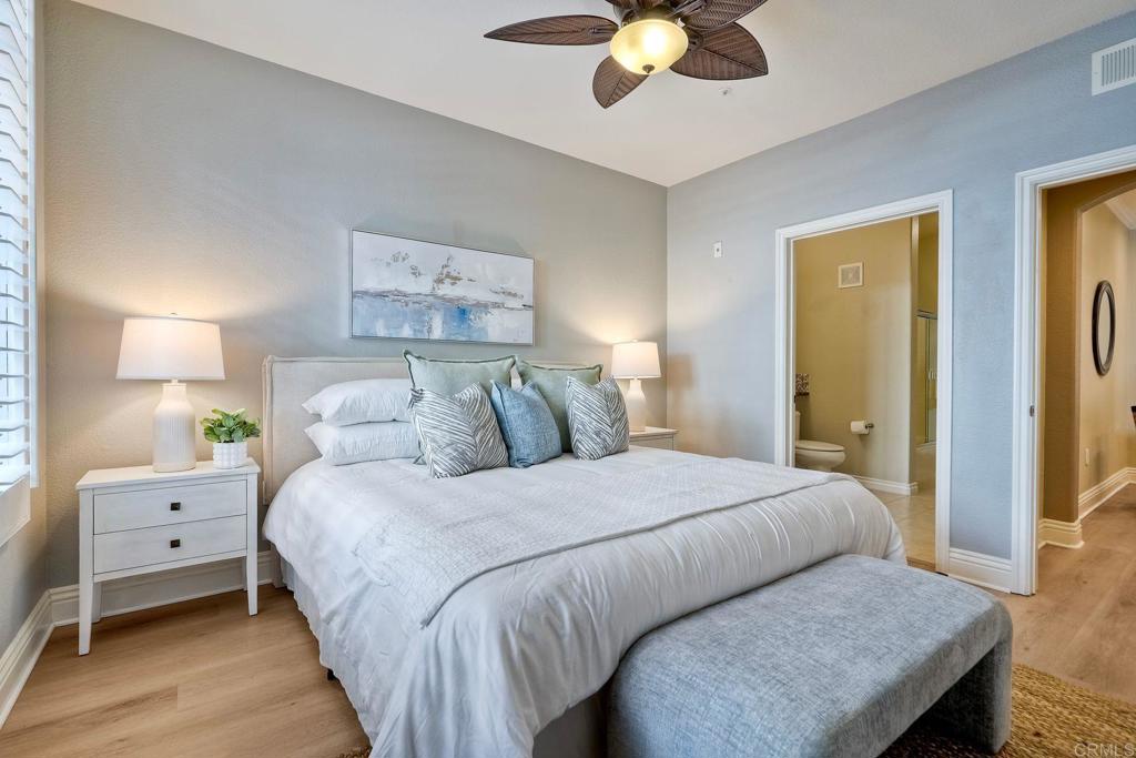 9263 Regents Road, Unit B106 La Jolla, CA 92037 - Photo 25 of 35 a bedroom with a bed and a chandelier