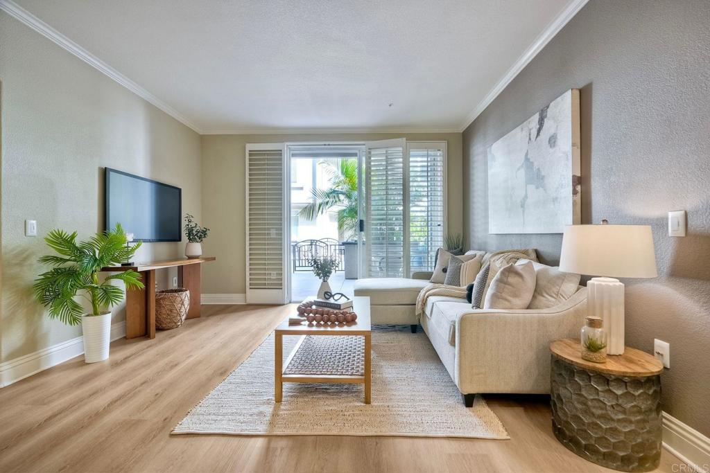 9263 Regents Road, Unit B106 La Jolla, CA 92037 - Photo 26 of 35 a living room with furniture large window and wooden floor