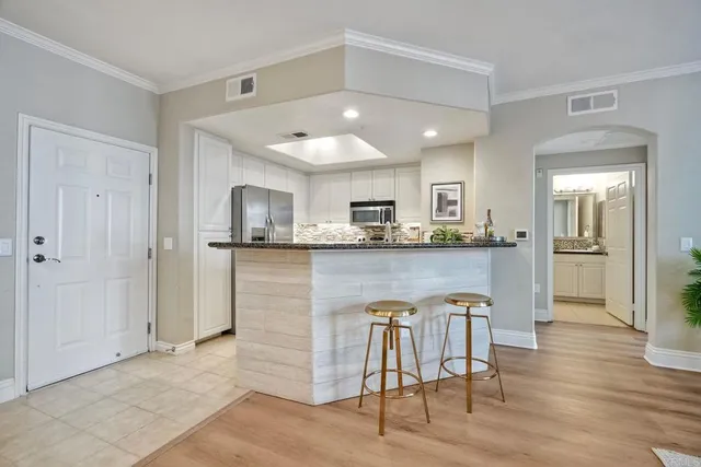 a kitchen with granite countertop a sink and stainless steel appliances