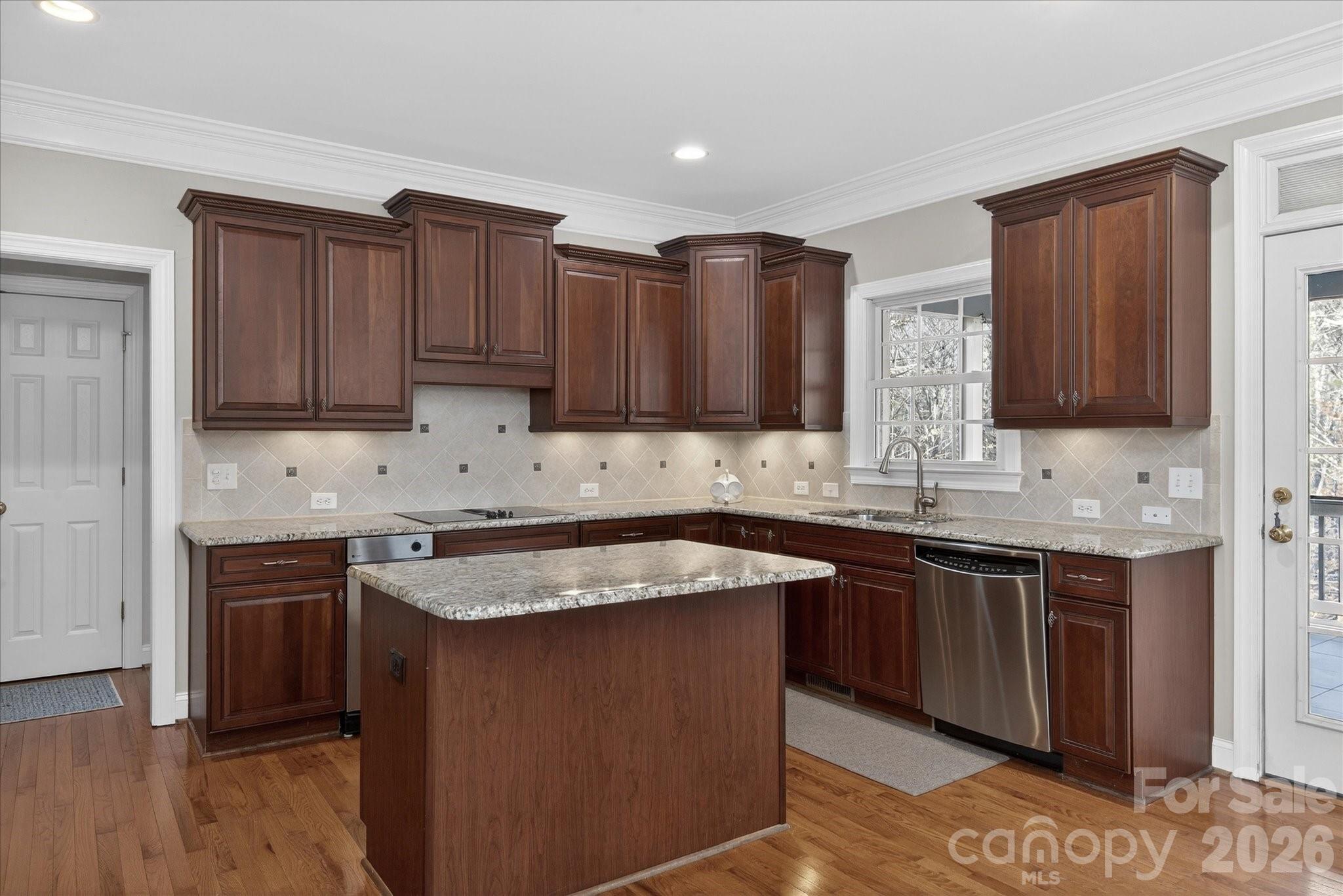 1237 Waynewood Drive Waxhaw, NC 28173 - Photo 11 of 32 a kitchen with stainless steel appliances granite countertop wooden cabinets a sink and dishwasher