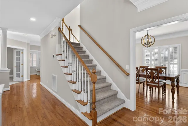 a bedroom with bed and a chandelier