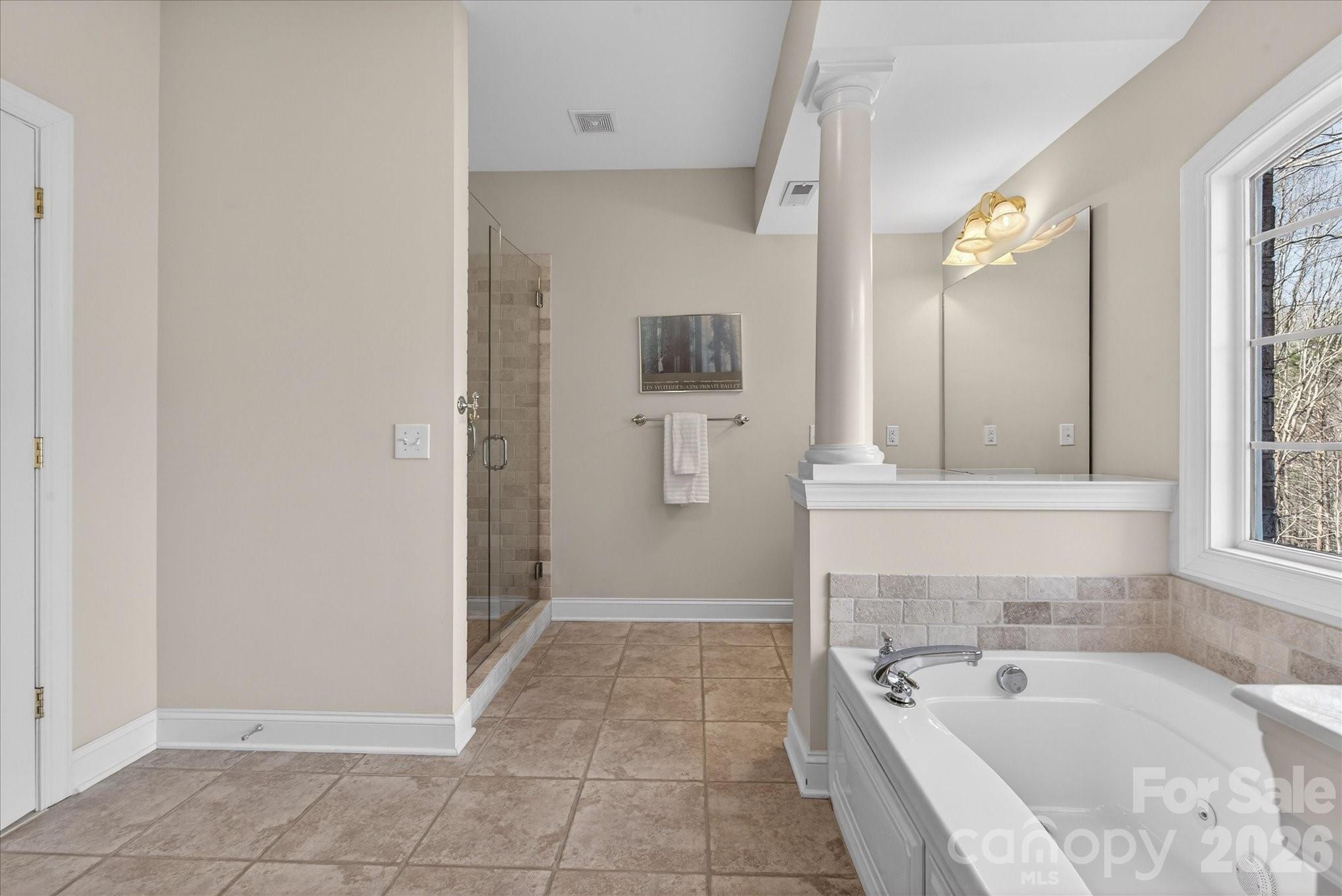 1237 Waynewood Drive Waxhaw, NC 28173 - Photo 19 of 32 a bathroom with a tub a sink and a large mirror