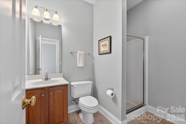 a view of staircase with lots of frames on wall and windows